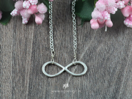 Infinity necklace sterling silver wooden background